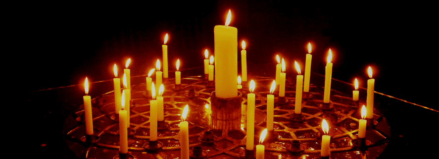 Votive candles shining in the darkness